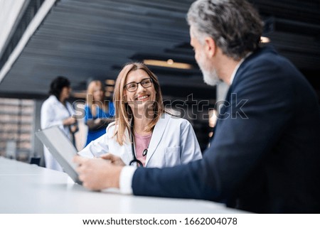 Doctor talking to a pharmaceutical sales representative.