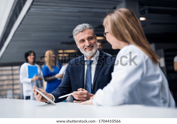 Doctor\
talking to a pharmaceutical sales\
representative.