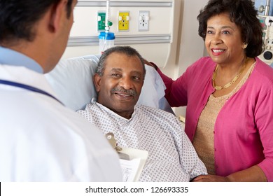 Doctor Talking To Senior Couple On Ward - Powered by Shutterstock