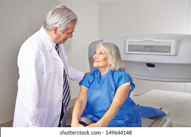 Doctor talking to senior patient prior to bone density measurement in radiology