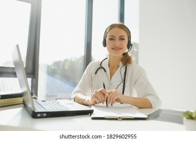 Doctor Talking With Sick Person Through Laptop Online System And Using Mobile Digital Tablet Computer Searching Patient Medical Records On The Database Files Document.