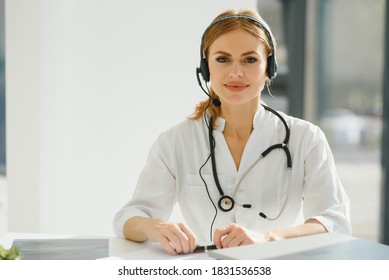 Doctor Talking With Sick Person Through Laptop Online System And Using Mobile Digital Tablet Computer Searching Patient Medical Records On The Database Files Document.