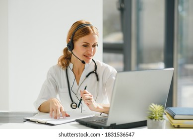 Doctor Talking With Sick Person Through Laptop Online System And Using Mobile Digital Tablet Computer Searching Patient Medical Records On The Database Files Document.