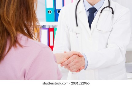 Doctor Is Talking With Woman Patient And Sitting In Medical Office