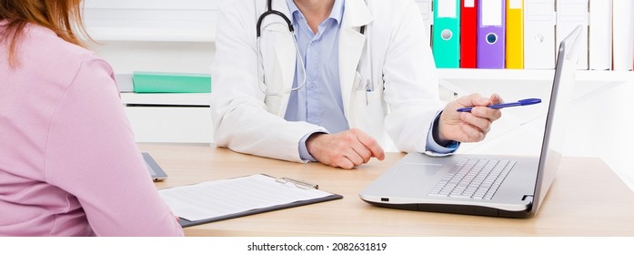 Doctor Is Talking With Woman Patient And Sitting In Medical Office