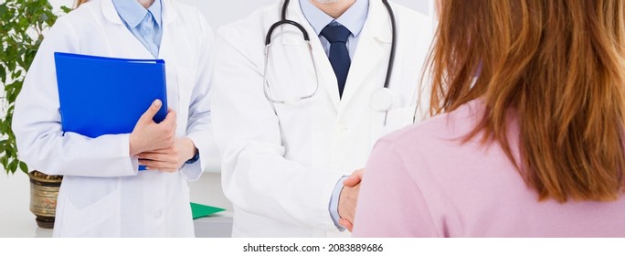 Doctor Is Talking With Woman Patient And Sitting In Medical Office