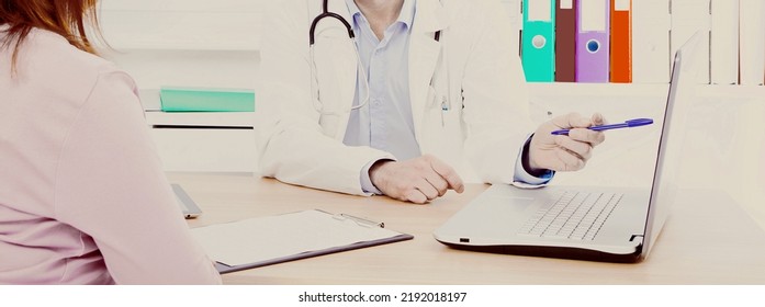 Doctor Is Talking With Woman Patient And Sitting In Medical Office