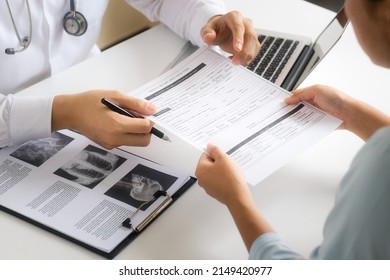 The doctor talks to patient, recommends treatment analyzes medical reports A thorough physical examination by x-ray, recording patient data with a laptop computer. - Powered by Shutterstock