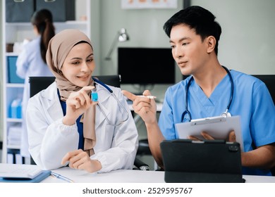  Doctor Talks With Professional Head Nurse or Surgeon, They Use Digital tablet Computer. Diverse Team of Health Care Specialists Discussing Test Result on desk in hospital 
 - Powered by Shutterstock