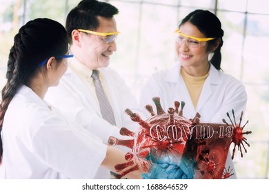 Doctor team while working analysis virus in lab with futuristic HUD screen tablet . Coronavirus disease named COVID-19.