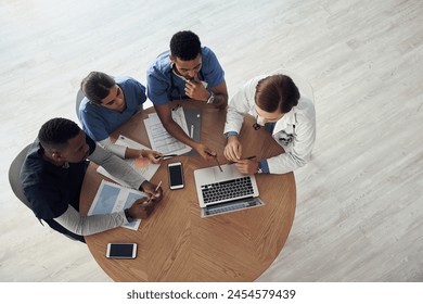 Doctor, teamwork and planning in meeting with computer, documents and training for medical residency in top view. Healthcare people, nurse and group leader with online research or solution for clinic - Powered by Shutterstock