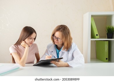 Doctor And Teenager,teen Girl At A Doctor's Consultation In A Medical Clinic