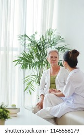 Doctor Telling Bad News To Worried Senior Female Patient Of Nursing Home