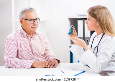 Doctor Is Telling To Her Patient How To Use Inhaler.