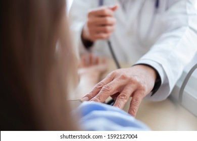 Doctor Testing Blood Pressure With Sick Patient In Hospital. Doctor Diagnose Patient's Sickness & Consider Medication For Ill Patient. Physician And Patient & Hyper Tension Testing Concept.