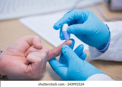 Doctor testing his patients blood at the hospital