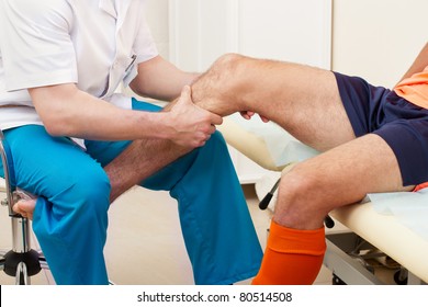 Doctor Testing A Knee For Stability Of Injured Football Player In Clinic