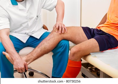 Doctor Testing A Knee For Stability Of Injured Football Player In Clinic