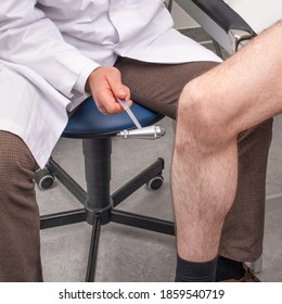 Doctor Testing The Patellar Reflex With A Reflex Hammer