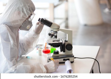 The doctor is testing a sample of biological tubes contaminated by Corona-virus Covid 19 and searching for a vaccine or Syrup against the virus. In the laboratory and film samples of infected lung