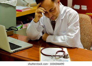 The Doctor Tired Of Work; Exhausted Overworked; Stressed Depressed; Medic Crying In Hospital Office. Malpractice, Treatment Error And Mistake Or Negligence. 
