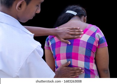 Doctor Touches The Back Plate For Causes Of Back Pain. Concept Of Physical Examination, Medical And Health Care.