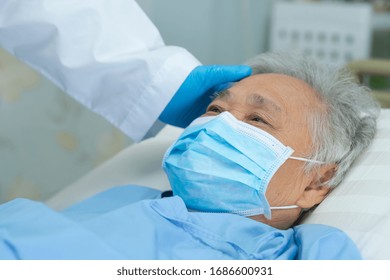 Doctor Touching And Checking Asian Senior Or Elderly Old Lady Woman Patient Wearing A Face Mask In Hospital For Protect Infection And Kill Novel Coronavirus (2019-nCoV) Covid-19 Virus.