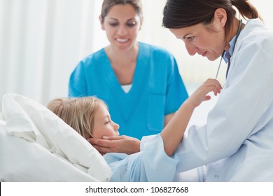 Doctor touching a child in hospital ward - Powered by Shutterstock