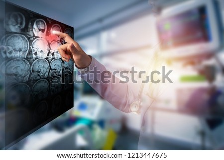 doctor touching computer screen of CT brain image in working room, illustration ECG and light and double exposure with woman doctor 