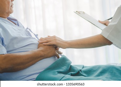 Doctor Touching Hands To Encouragement Mental Of Elderly Patient After Surgery At Bed In Hospital.