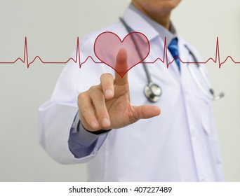 Doctor Touching Heart Shape Button On EKG Graph Monitor.