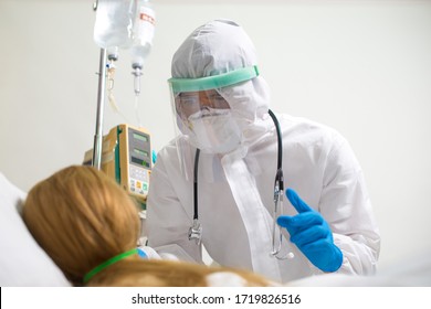 Doctor Treating Patients With Coronavirus Covid-19 At The Intensive Care Unit (ICU) In The Hospital.