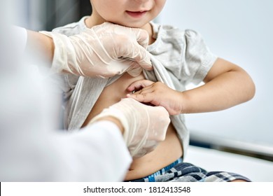 Doctor trying to listen to baby heartbeat. Physical examination of the 1-year-old baby boy. Well-baby exam. Regularly scheduled medical check-up