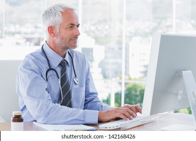 Doctor Typing On His Computer In The Office