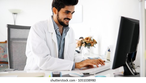 Doctor typing and using his computer