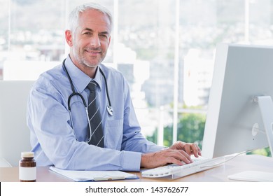 Doctor Typing And Using His Computer In The Office