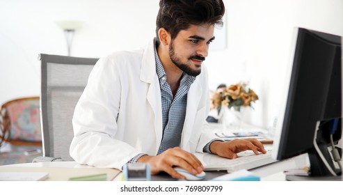 Doctor typing and using his computer