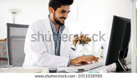 Doctor typing and using his computer