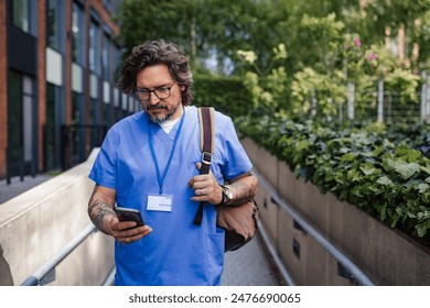 Doctor in uniform going home from work, texting on smartphone. Work-life balance of healthcare worker. - Powered by Shutterstock