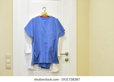 Doctor Uniform On A Hanger At Home, A Nurse Robe Hanging On The Bedroom Door