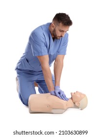 Doctor in uniform practicing first aid on mannequin against white background - Shutterstock ID 2103630899