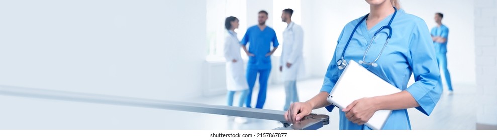 Doctor In Uniform With Tablet At Workplace, Space For Text. Banner Design