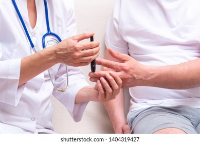 Doctor use blood glucose detector for patient  - Shutterstock ID 1404319427