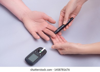 Doctor use blood glucose detector for patient 