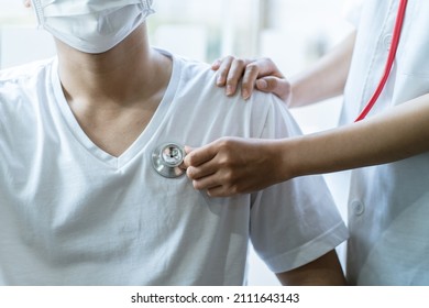 Doctor use stethoscope, checking up heart beat, auscultation in doctor office at hospital. Patient worker has to get medical checkup every year for her health or medical checkup cardiologist.