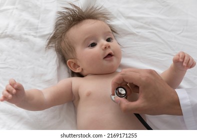 Doctor Use Stethoscope Listens Baby Heart Beat, Check Breath Examining Lungs, 0-6 Infant Lying On White Sheets During Regular Pediatrician Visit At Home, Close Up. Healthcare, Medical Checkup Concept