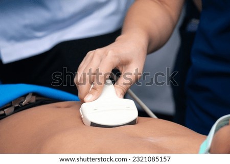 doctor use an ultrasound to examine the patient's body to find out the cause of the illness. extended focused assessment with sonography in trauma 

