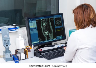 Doctor Using Computer To Analyzing Brain MRI In Radiology Room Of The Hospital