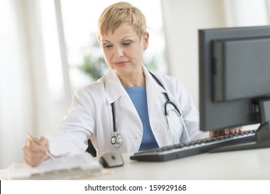 Doctor Using Computer In Office