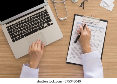 Doctor Using Computer On Doctor Desk. View From Above. Vintage Style.